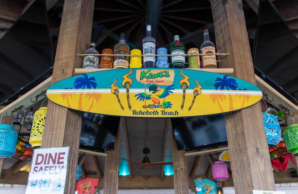 Top of tiki bar with logo and bottles