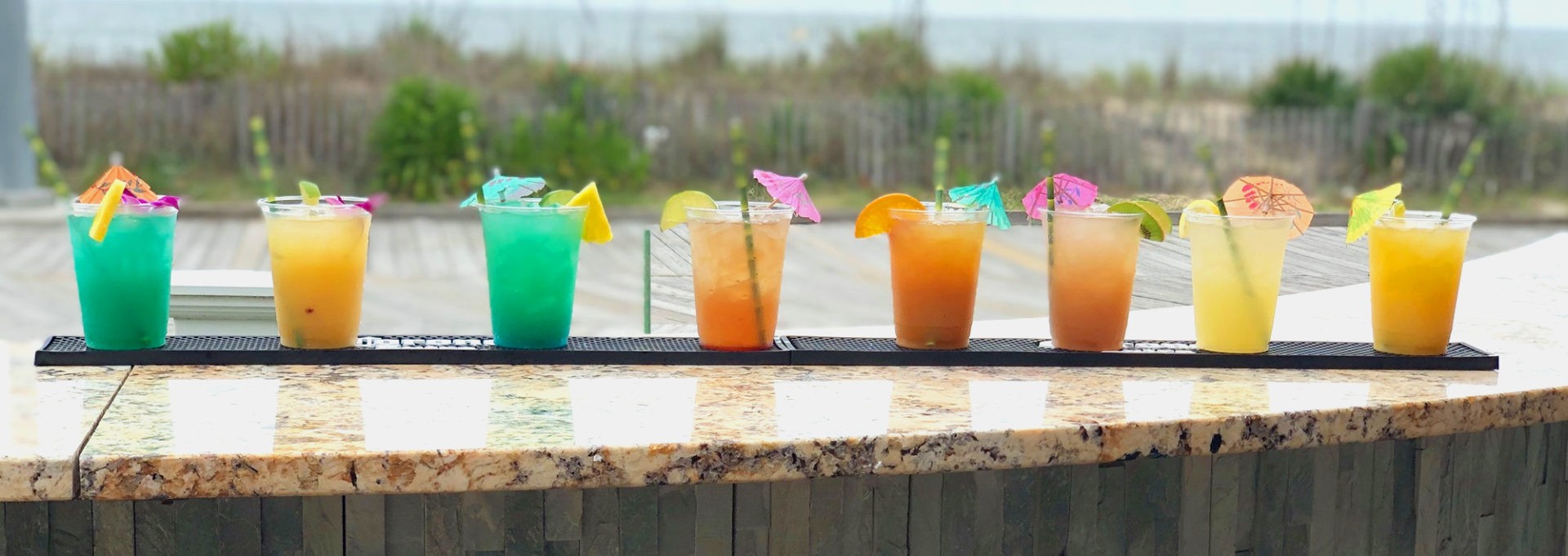 Variety of tiki hut drinks on the outdoor bar counter